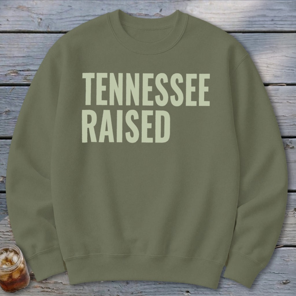 Green sweatshirt with "TENNESSEE RAISED" printed in light beige text.