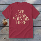 Maroon t-shirt with beige text reading "WE SPEAK MOUNTAIN HERE".