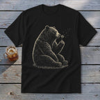 Black t-shirt with graphic of a bear sitting and blowing on a dandelion.