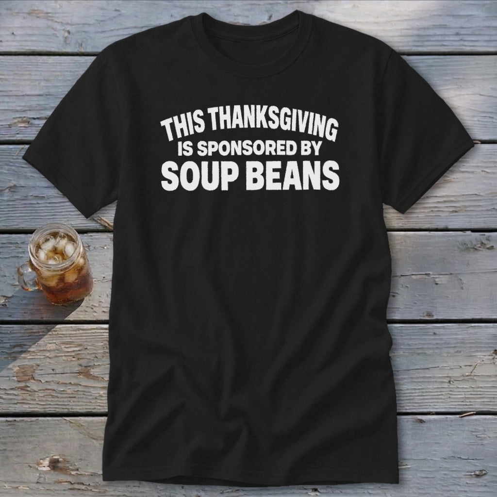 Black short-sleeved t-shirt with white arched text reading THIS THANKSGIVING IS SPONSORED BY SOUP BEANS.