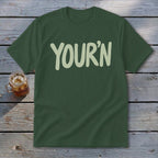 Dark green t-shirt with "YOUR'N" printed in light green text.