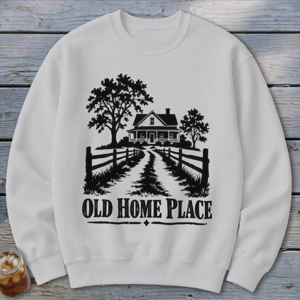 White sweatshirt with a black graphic of a house and trees, reading "OLD HOME PLACE."