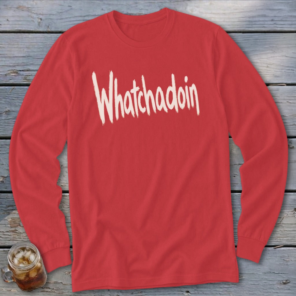 Red long sleeve shirt with "Whatchadoin" text in cream brushstroke font.