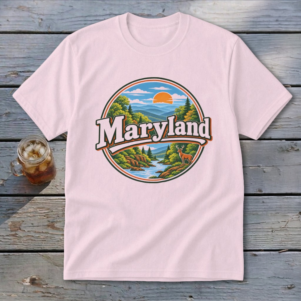 Pink t-shirt with a circular graphic of mountains, river, trees, and deer, reading "Maryland".