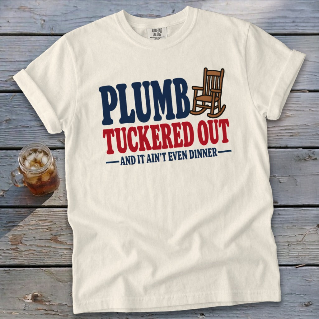 Cream t-shirt with "PLUMBER TUCKERED OUT -AND IT AIN'T EVEN DINNER-" text and rocking chair.