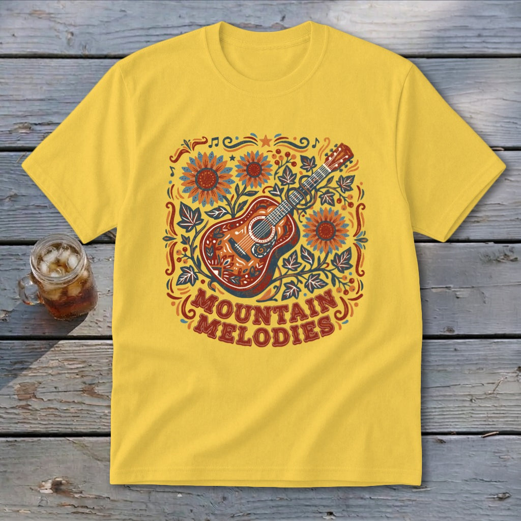 A yellow t-shirt features a colorful acoustic guitar graphic with sunflowers, foliage, and the text MOUNTAIN MELODIES.