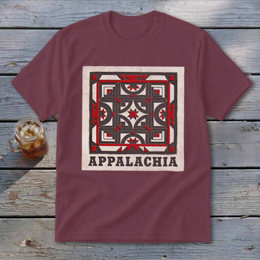 Maroon t-shirt featuring a square geometric quilt pattern and the text APPACHIA on a wooden surface.