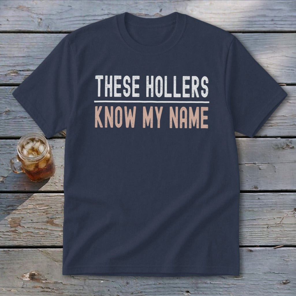 Navy t-shirt with white and peach text reading "THESE HOLLERS KNOW MY NAME".