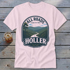 Pink t-shirt with graphic "All Roads Lead to the Holler" and mountain landscape.