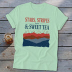Light green t-shirt with red, white, and blue text reading Stars, Stripes & Sweet Tea.