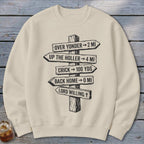 Beige crewneck sweatshirt featuring a black graphic of a wooden signpost with rustic directional distances.