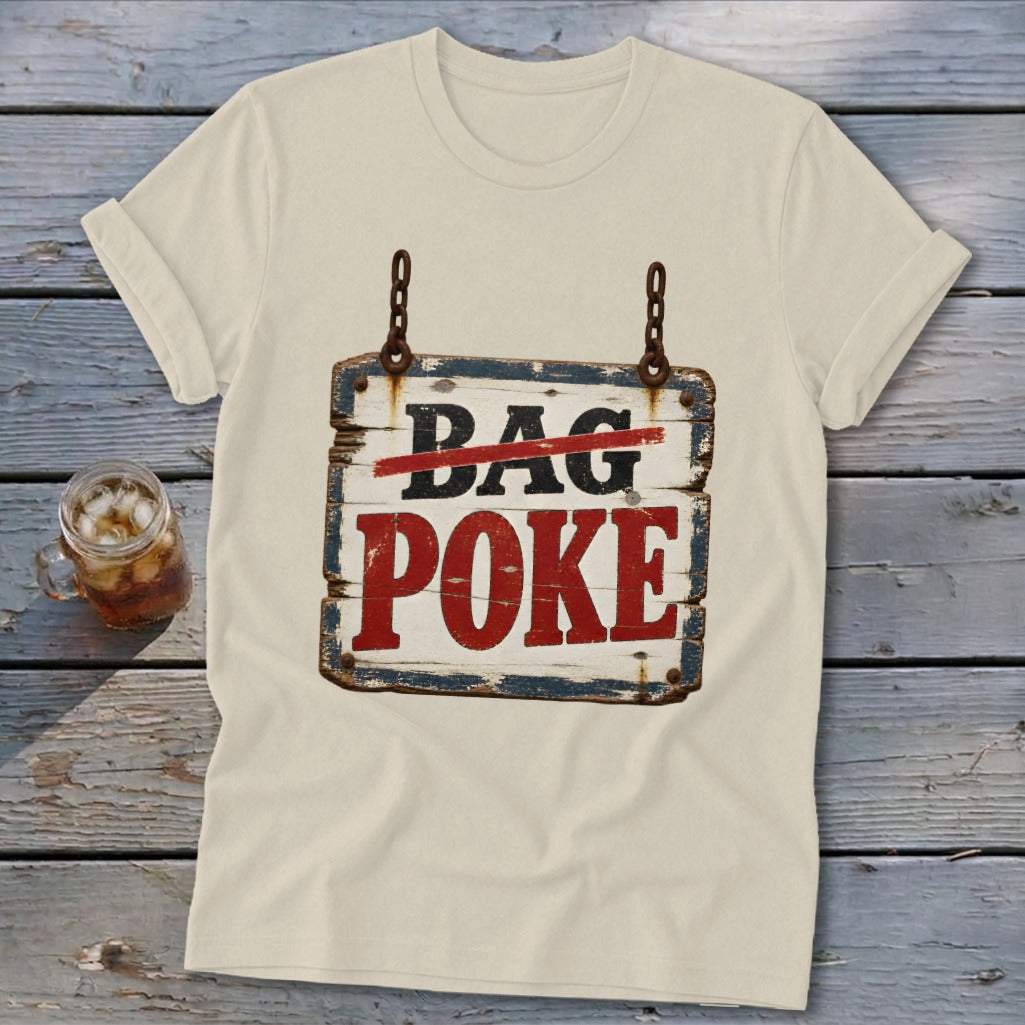 A cream-colored t-shirt with rolled sleeves features a rustic wooden sign graphic that reads BAG POKE.