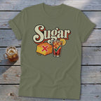 Olive green crewneck t-shirt featuring a retro graphic with the text Sugar, cornbread, and iced tea.