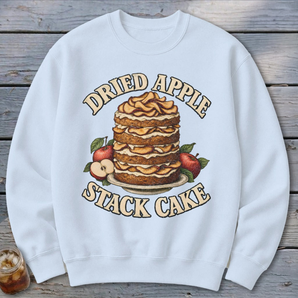 Sweatshirt with a "Dried Apple Stack Cake" graphic featuring a tall cake and apples.