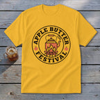Yellow t-shirt with circular "Apple Butter Festival" graphic featuring a kettle over a campfire.
