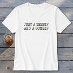 White v-neck t-shirt with black text "JUST A MESSIN AND A GOMMIN".