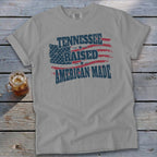 Gray t-shirt with "Tennessee Raised American Made" text and American flag graphic.