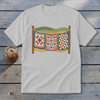 Light gray t-shirt featuring a graphic of three patchwork quilts hanging on a clothesline outdoors.