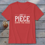 Red v-neck t-shirt with white text "JUST A PIECE DOWN THE ROAD".