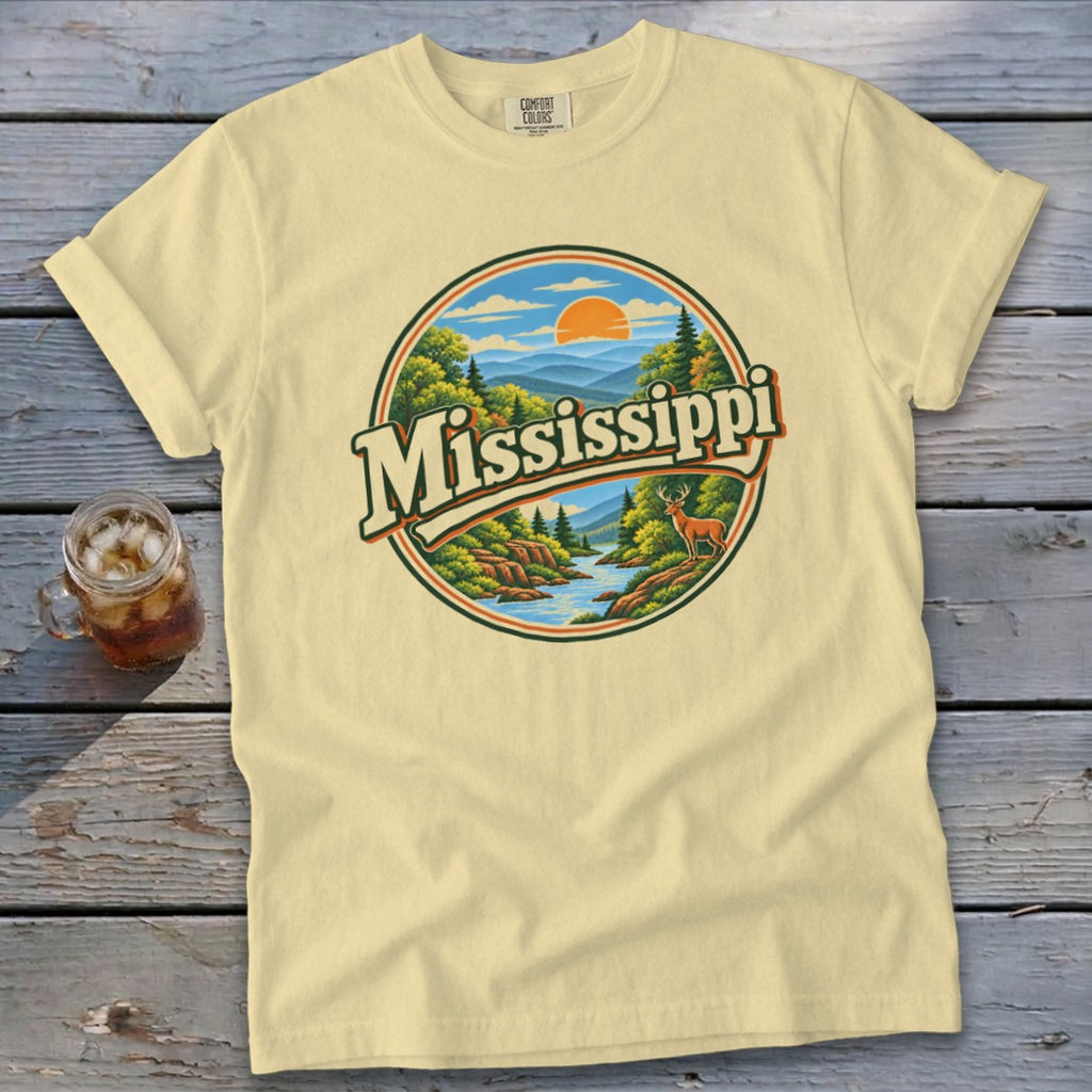 Light yellow t-shirt with circular Mississippi nature graphic featuring deer and river.