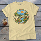 Light yellow t-shirt with circular Mississippi nature graphic featuring deer and river.