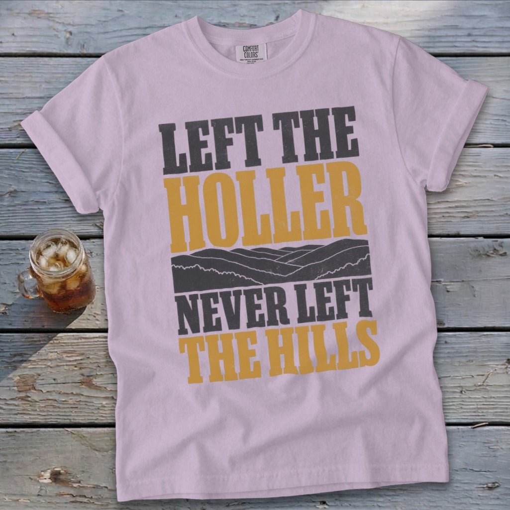 Light purple t-shirt with "LEFT THE HOLLER NEVER LEFT THE HILLS" text.