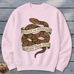 Pink sweatshirt with coiled snake design and text "Respect the mountains watch your step".