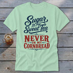 Light green crewneck t-shirt featuring dark blue and red text that reads Sugar in my Sweat Tea Never in my Cornbread.