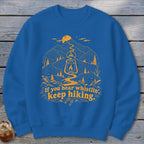Blue sweatshirt with yellow graphic of mountains, lantern, and text "If you hear whistlin', keep hiking."