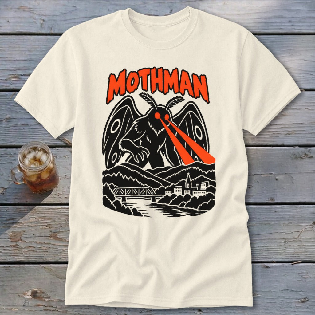 Cream t-shirt with Mothman graphic, red eyes shooting lasers over a town and bridge.