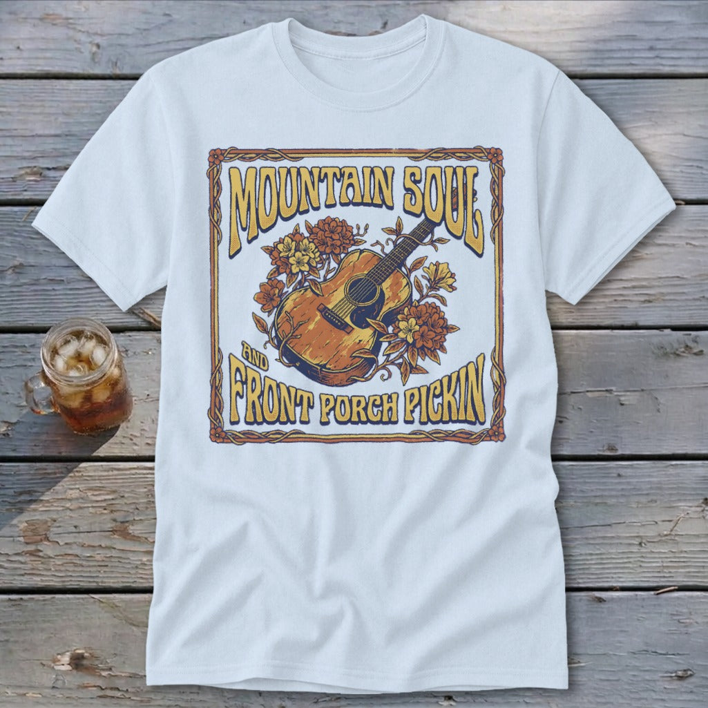 T-shirt with graphic of acoustic guitar and flowers, text "MOUNTAIN SOUL AND FRONT PORCH PICKIN".