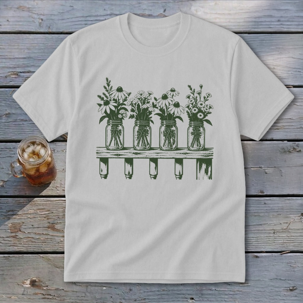 Light grey t-shirt featuring a green graphic of four mason jars filled with wildflowers on a shelf.