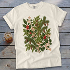 White t-shirt with a central botanical print of pine, holly, berries, and pinecones.
