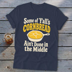 Navy blue t-shirt featuring the text "Some of Y'all's Cornbread Ain't Done in the Middle" and a skillet graphic.