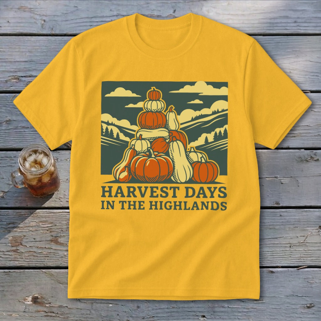 Gold t-shirt featuring a graphic of stacked pumpkins, hills, and the text Harvest Days in the Highlands.