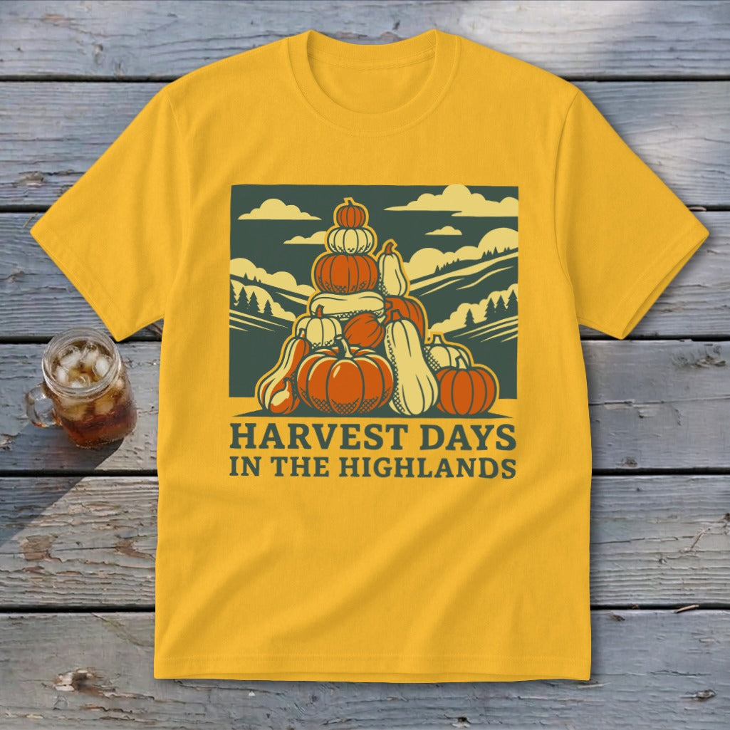 Gold t-shirt featuring a graphic of stacked pumpkins, hills, and the text Harvest Days in the Highlands.