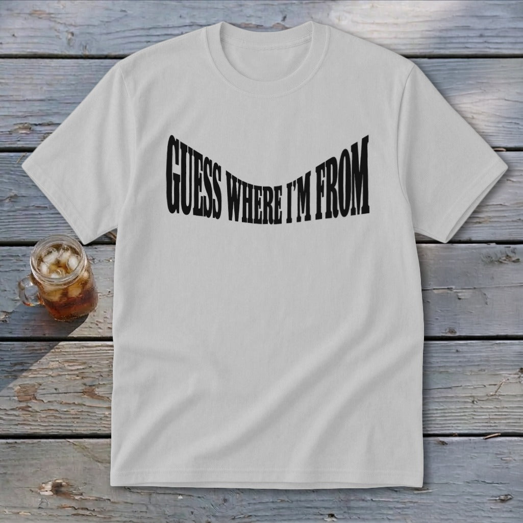White t-shirt with black text reading "GUESS WHERE I'M FROM" in a wavy font.