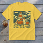 Yellow t-shirt with a graphic of a stack of pumpkins and text reading HARVEST DAYS IN THE HIGHLANDS.