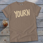 Brown t-shirt with "YOUR'N" text and a glass of iced tea.