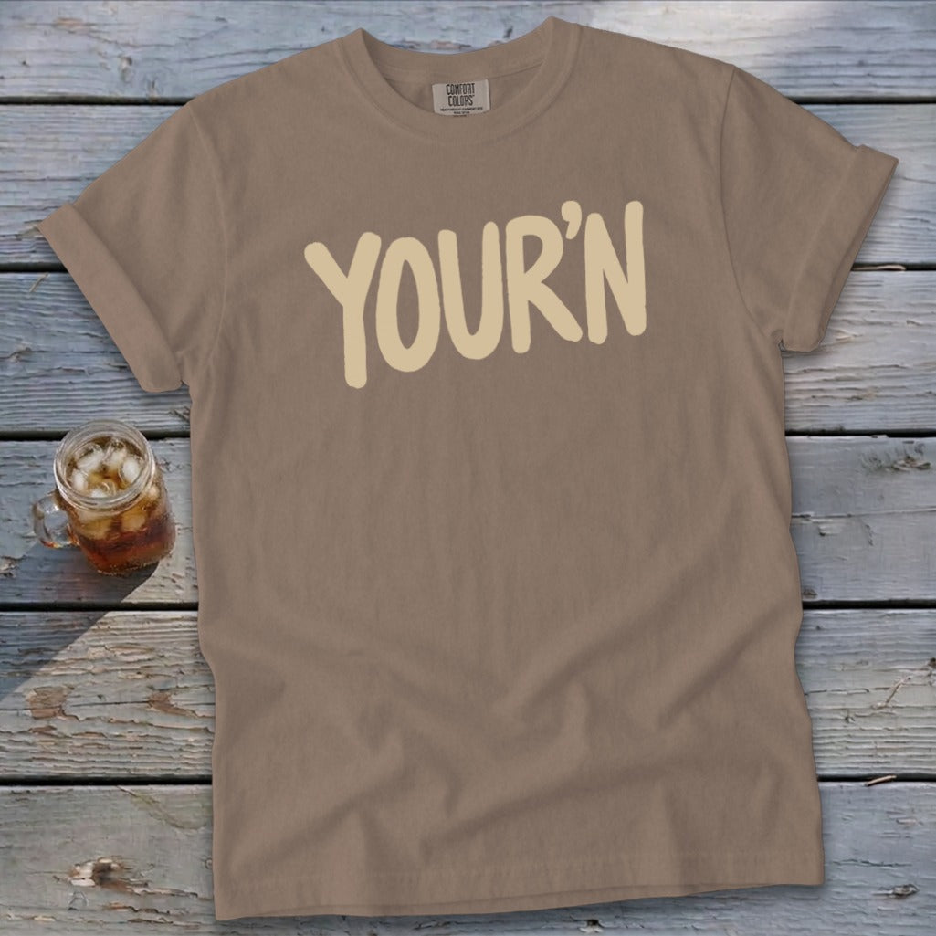 Brown t-shirt with "YOUR'N" text and a glass of iced tea.