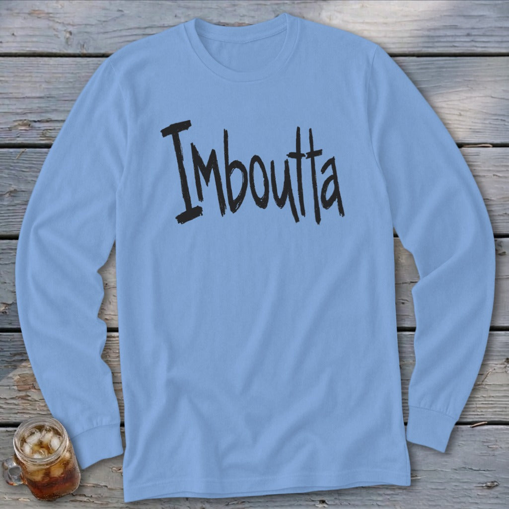Light blue long-sleeve shirt with black text "Imboutta" and a glass of iced drink.