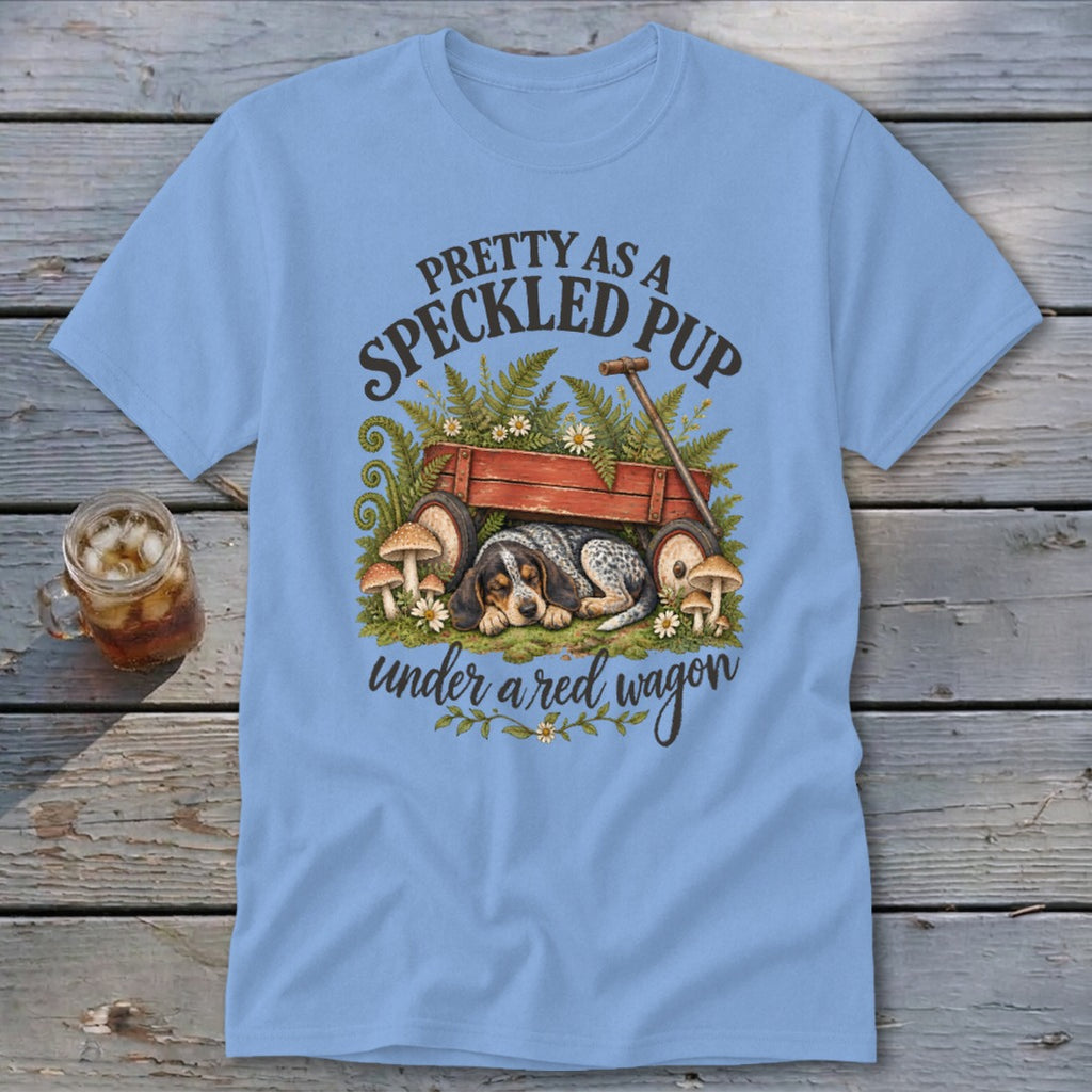 Blue t-shirt with a speckled puppy sleeping under a red wagon and text "Pretty as a speckled pup".