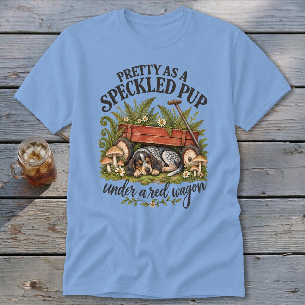 Blue t-shirt with a speckled puppy sleeping under a red wagon and text "Pretty as a speckled pup".