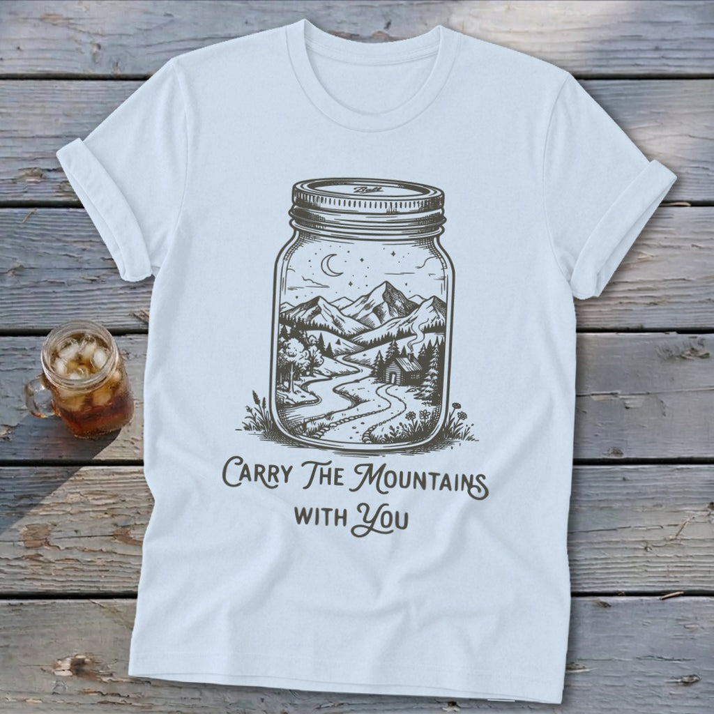 Light blue t-shirt featuring a mason jar graphic enclosing a mountain landscape and text reading Carry The Mountains With You.