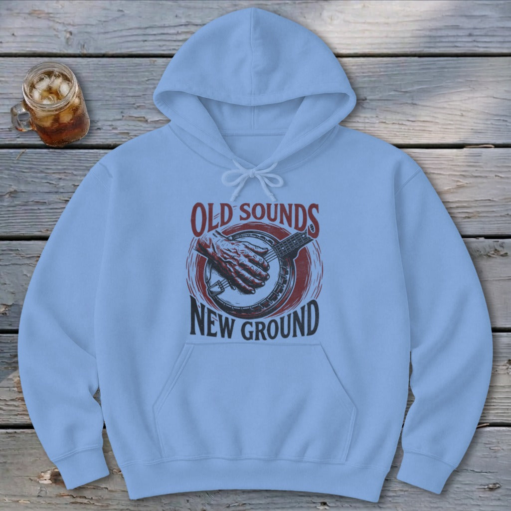 Light blue hooded sweatshirt with a graphic of a hand playing a banjo and text reading Old Sounds New Ground.