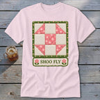 Pink t-shirt with a Shoo Fly quilt block graphic and text.