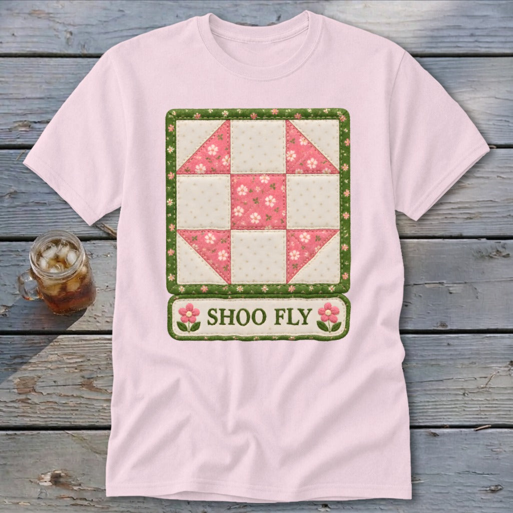Pink t-shirt with a Shoo Fly quilt block graphic and text.
