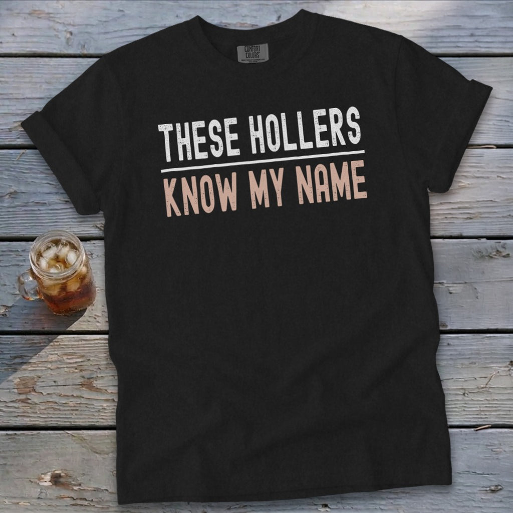 Black Comfort Colors t-shirt with "THESE HOLLERS KNOW MY NAME" graphic.