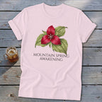 Pink t-shirt with a red trillium flower and "MOUNTAIN SPRING AWAKENING" text.