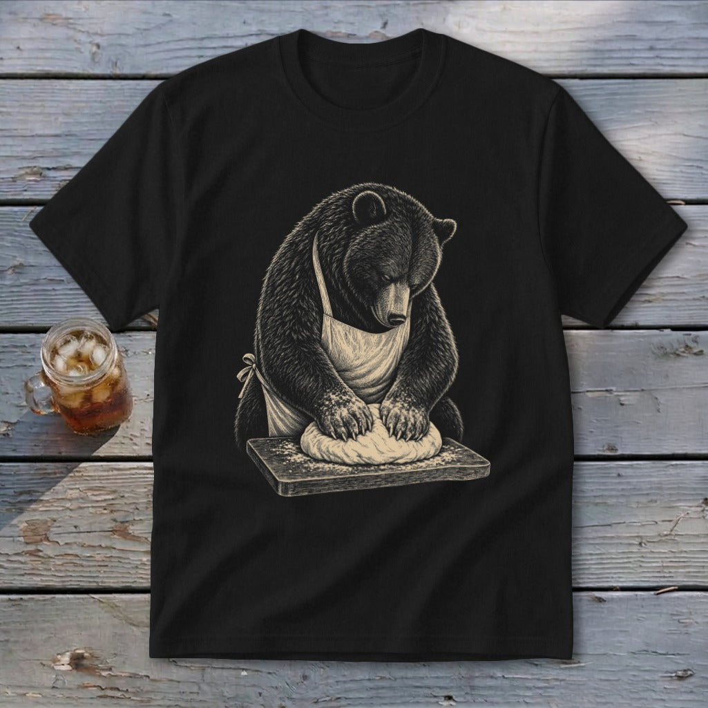 Black t-shirt with a bear in an apron kneading dough on a wooden board.